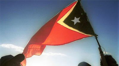 People wave the East Timorese flag during independence day celebrations in Dili, 2002