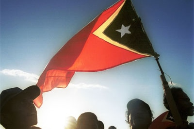 People wave the East Timorese flag during independence day celebrations in Dili, 2002 (ABC)