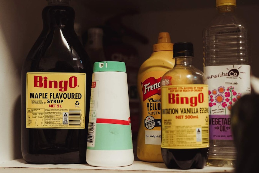 Bottles of Bingo Maple Syrup, French's American mustard and Bingo vanilla essence sit on a low shelf.