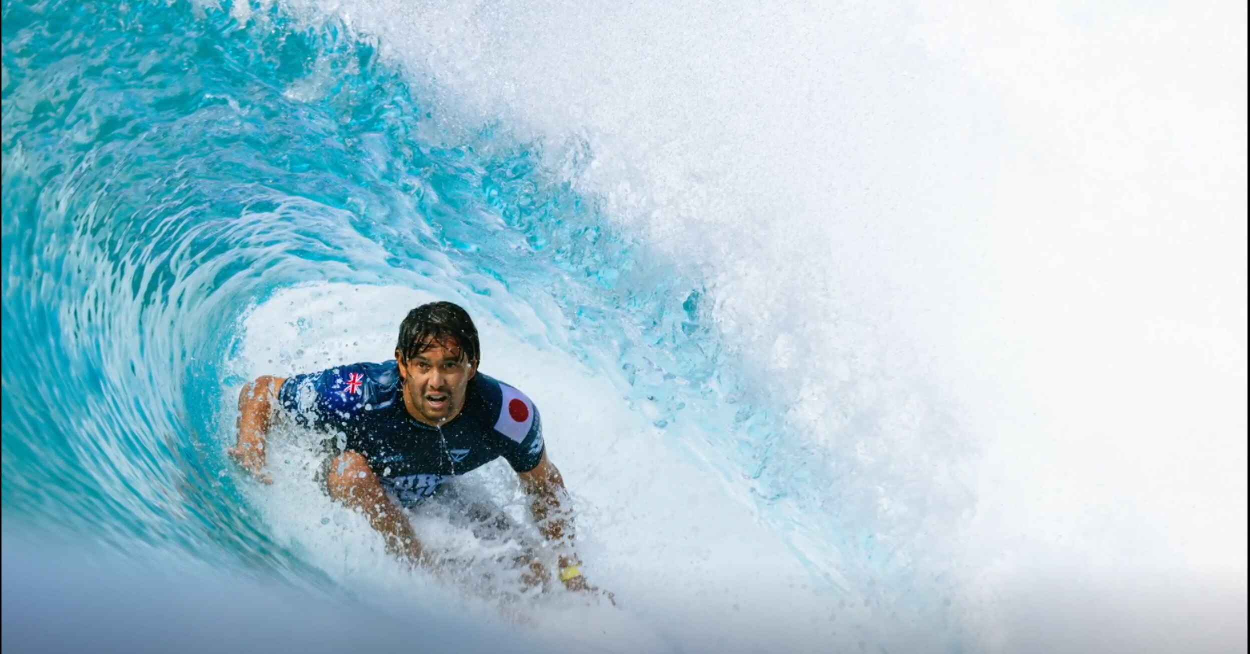 Man on surfboard in the middle of a wave.