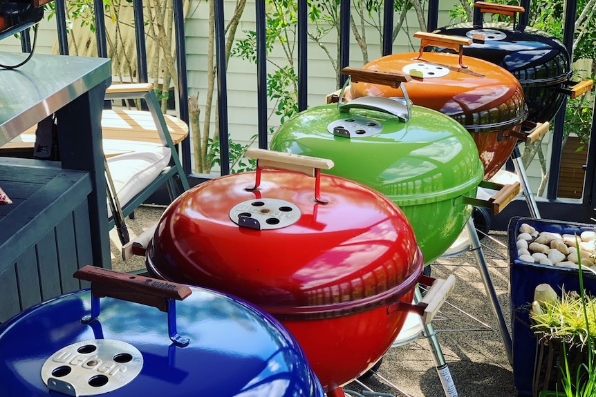 Different coloured kettle barbeques.