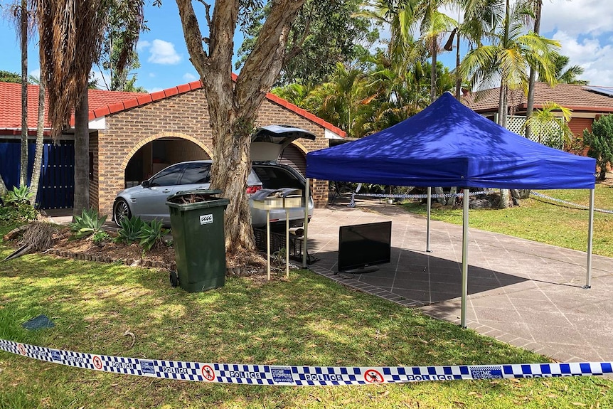 Police crime scene at house where a 37-year-old woman was found unconscious in driveway with a serious head injury.