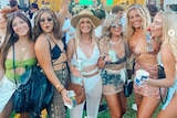 Six girls partying at an outdoor concert venue.