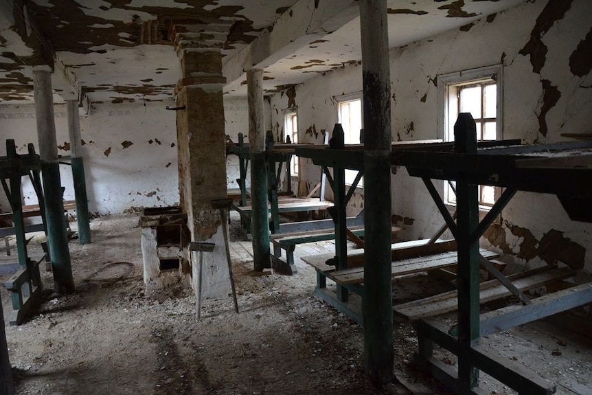 Gulag barracks interior revealing bunk beds.