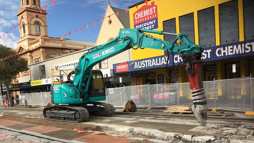 Machinery digs up the tram tracks along Glenelg's Jetty Road.