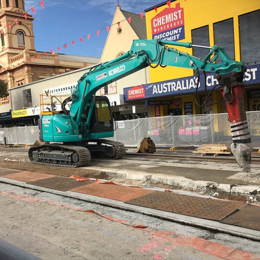 Machinery digs up the tram tracks along Glenelg's Jetty Road.