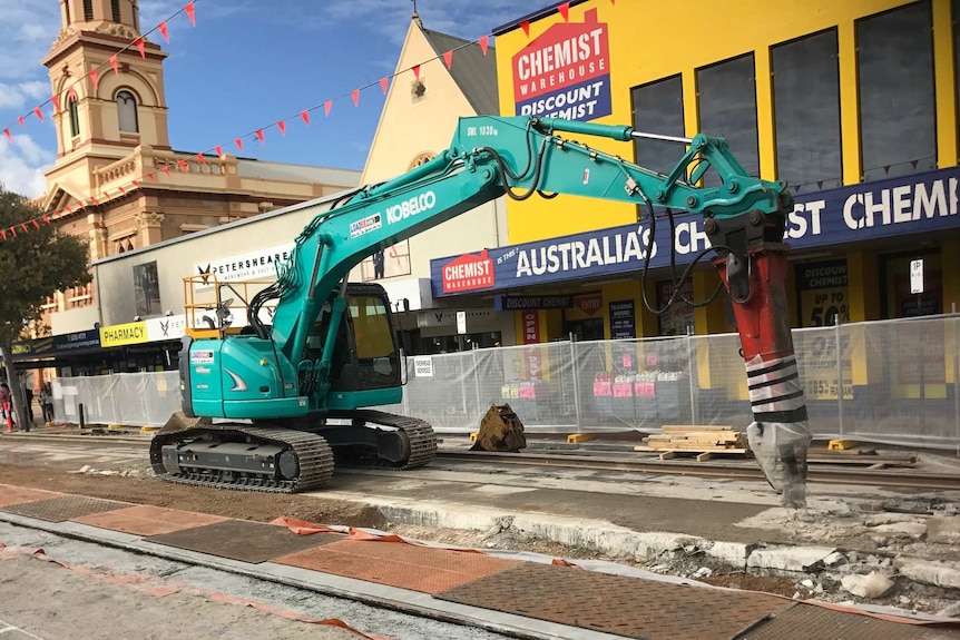 Machinery digs up the tram tracks along Glenelg's Jetty Road.