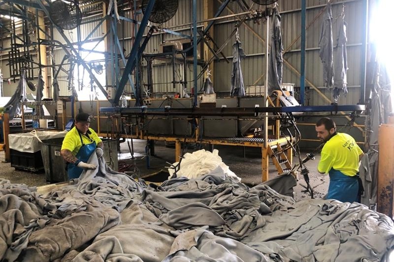 Photo of bundles of partly processed cattle hides
