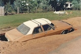 Car stranded in sinkhole in Charleville after 1990 flood.