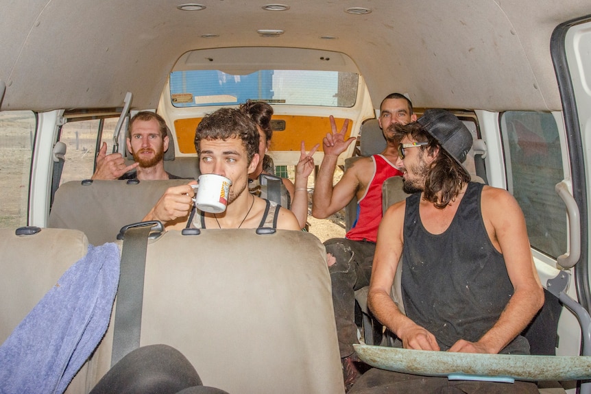 A group of sheep shearers in a van