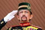 Brunei's Sultan Hassanal Bolkiah salutes during a ceremonial guard of honour