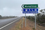 A large, green road sign shows the turn-off to Munglinup and the Munglinup Roadhouse