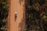 An aerial view of a 4WD on a dirt road in remote Arnhem Land.