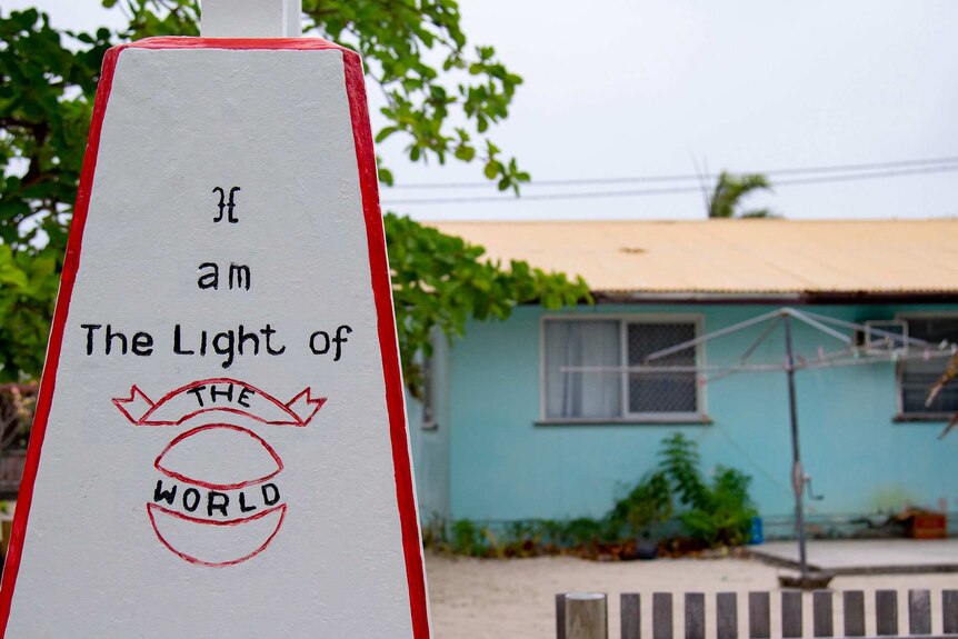 A house with a sign out the front that reads, 'I am the light of the world'.