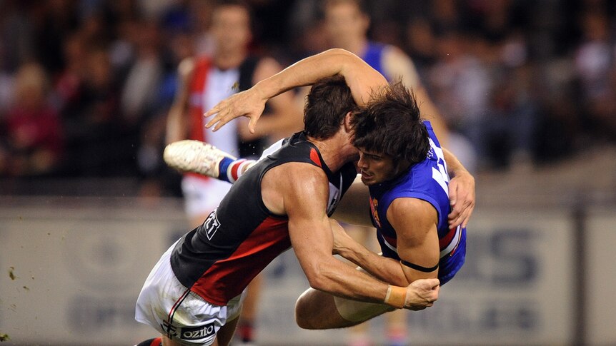 Collaring the Dogs ... Lenny Hayes lays a tackle on Easton Wood at Docklands.
