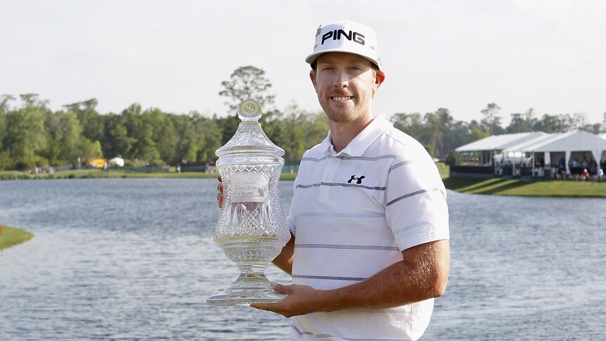 Spoils of victory ... Hunter Mahan holds the winners trophy