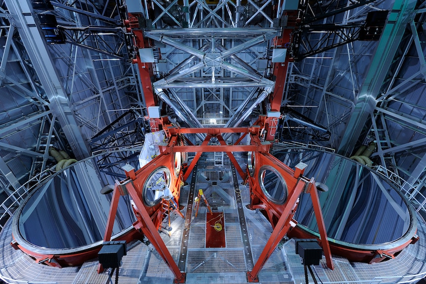 A large room with two enormous mirrors arranged side-by-side and facing upwards