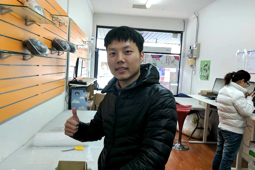 Polar Express Carnegie store manager Tracy Li stands in his logistic shop.