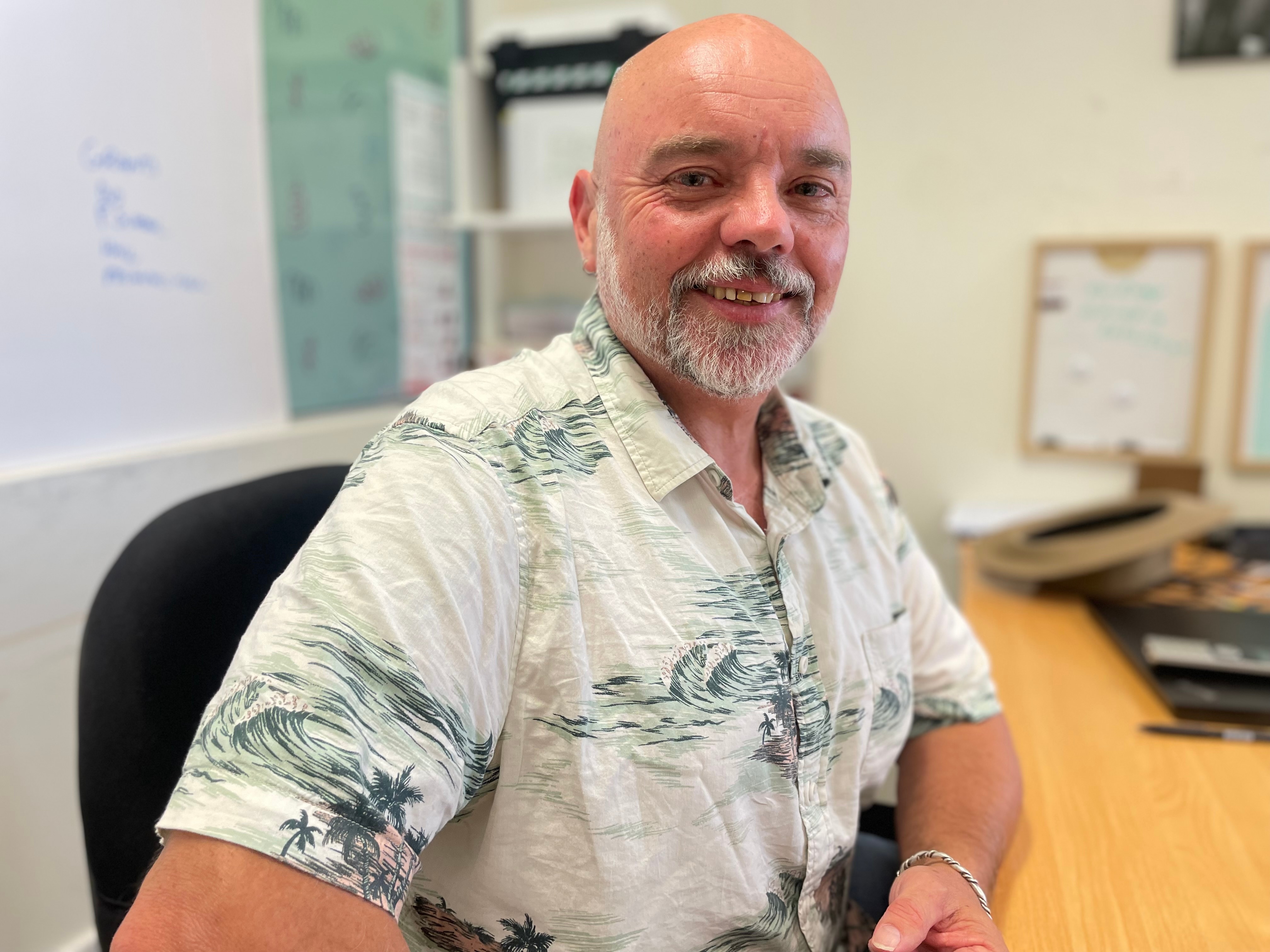 Portrait of Rich Lanham sitting at a desk.