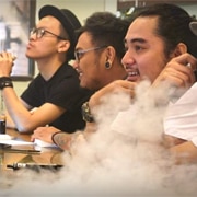Young men vape in an inner-city vape bar in Jakarta, Indonesia