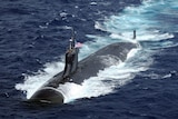 Submarine with Unites States flag is semi submerged in water