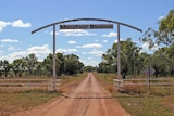 a sign above a cattle station driveway.