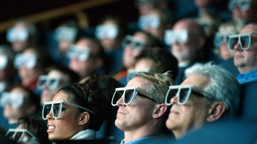 Audience members wearing 3D glasses