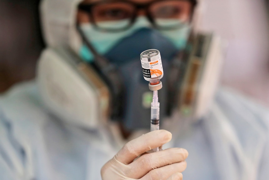 A medical worker shows a vial of the Sinovac COVID-19 vaccine 