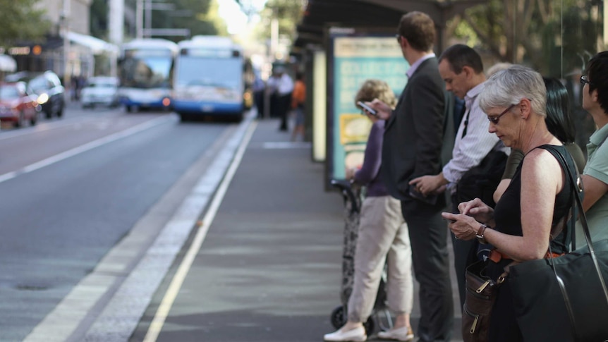 Woman waits for bus.