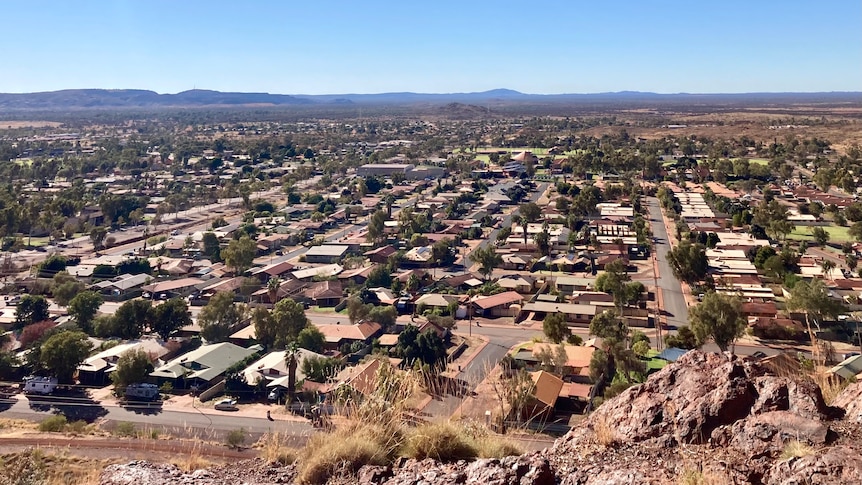 An aerial shot of rows of houses in a dusty outback town. 