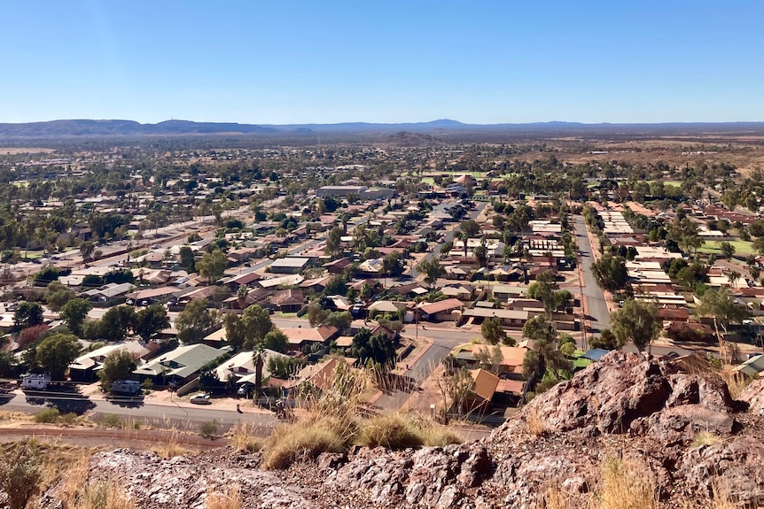 An aerial shot of rows of houses in a dusty outback town. 