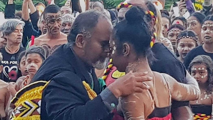 Two dancers embrace after performing the Haka and the Corroboree at Kings Park.