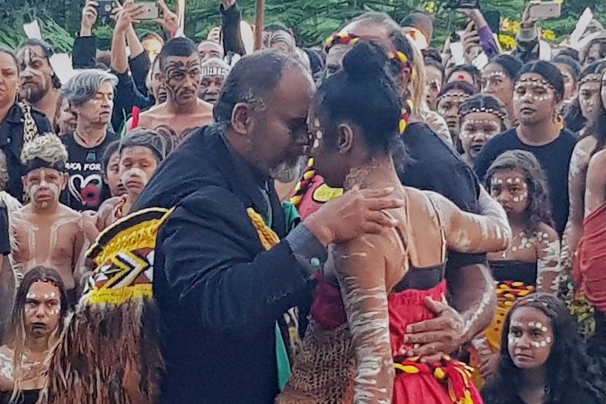 Two dancers embrace after performing the Haka and the Corroboree at Kings Park.
