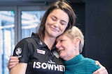 Sharni Layton hugs her mother at her retirement announcement.