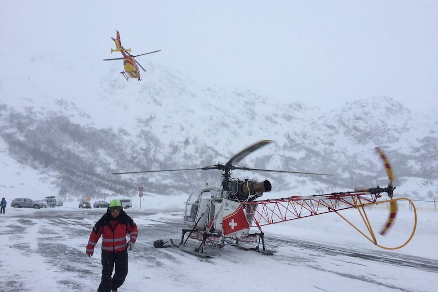 Rescue workers and helicopters take part in search for avalanche victims in Swiss Alps