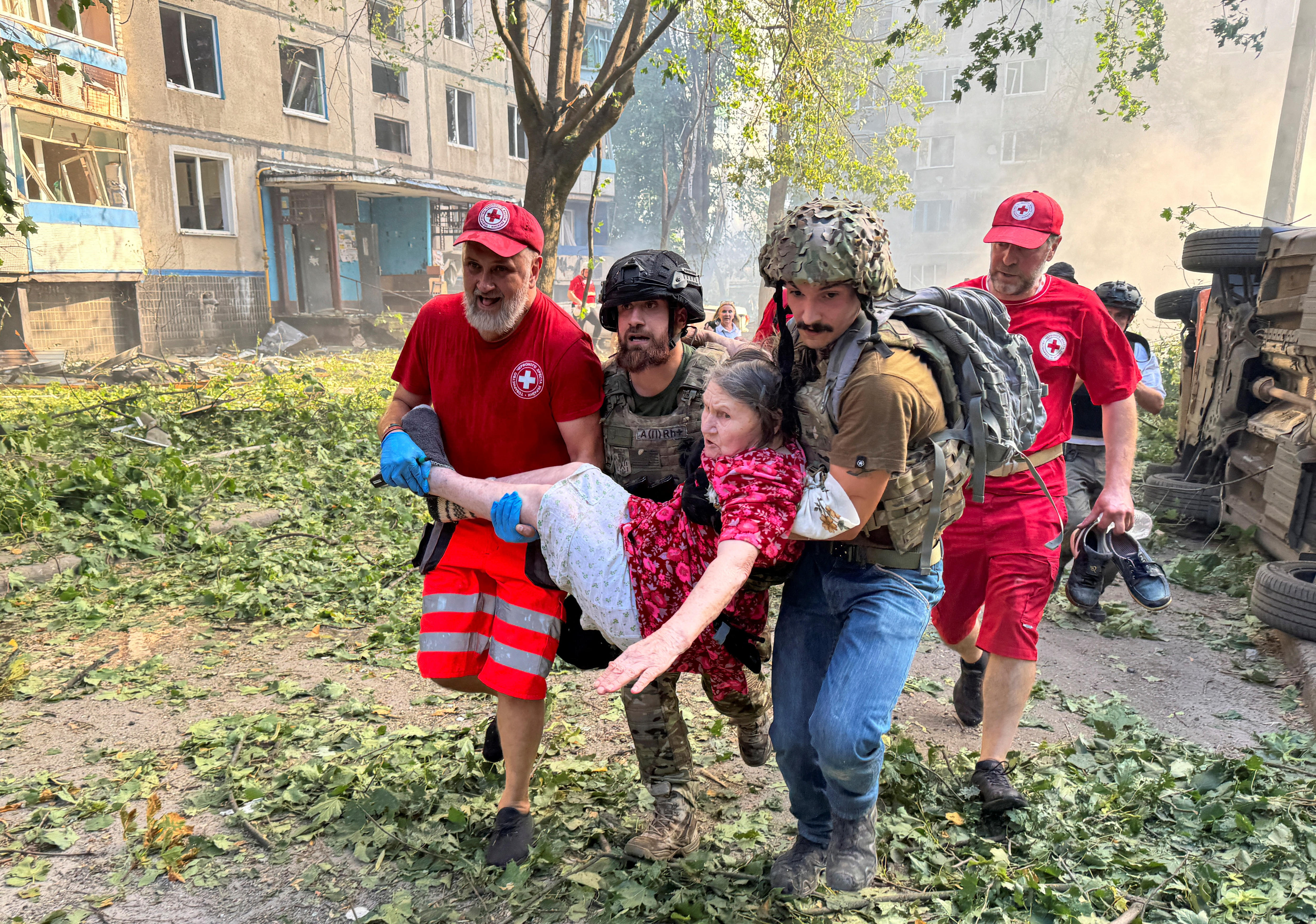 Paramedics carrying a woman away from the site of a bombing