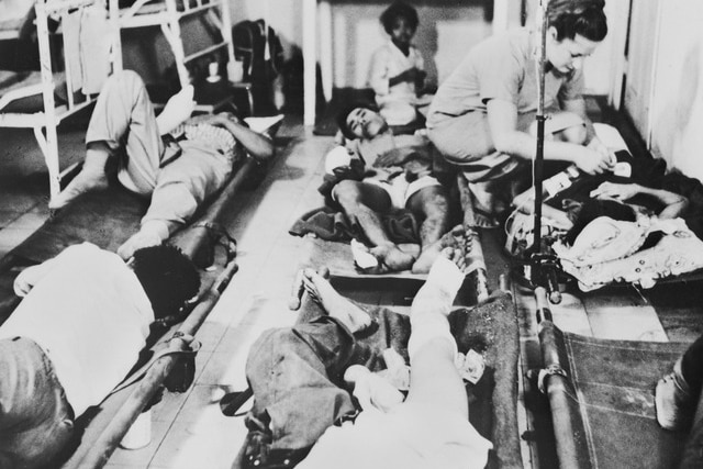 Six people lying on stretchers after surgery.