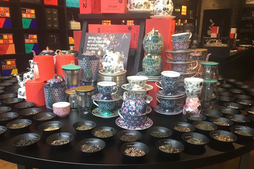 A variety of tea and tea cups and pots on display at a T2 store.