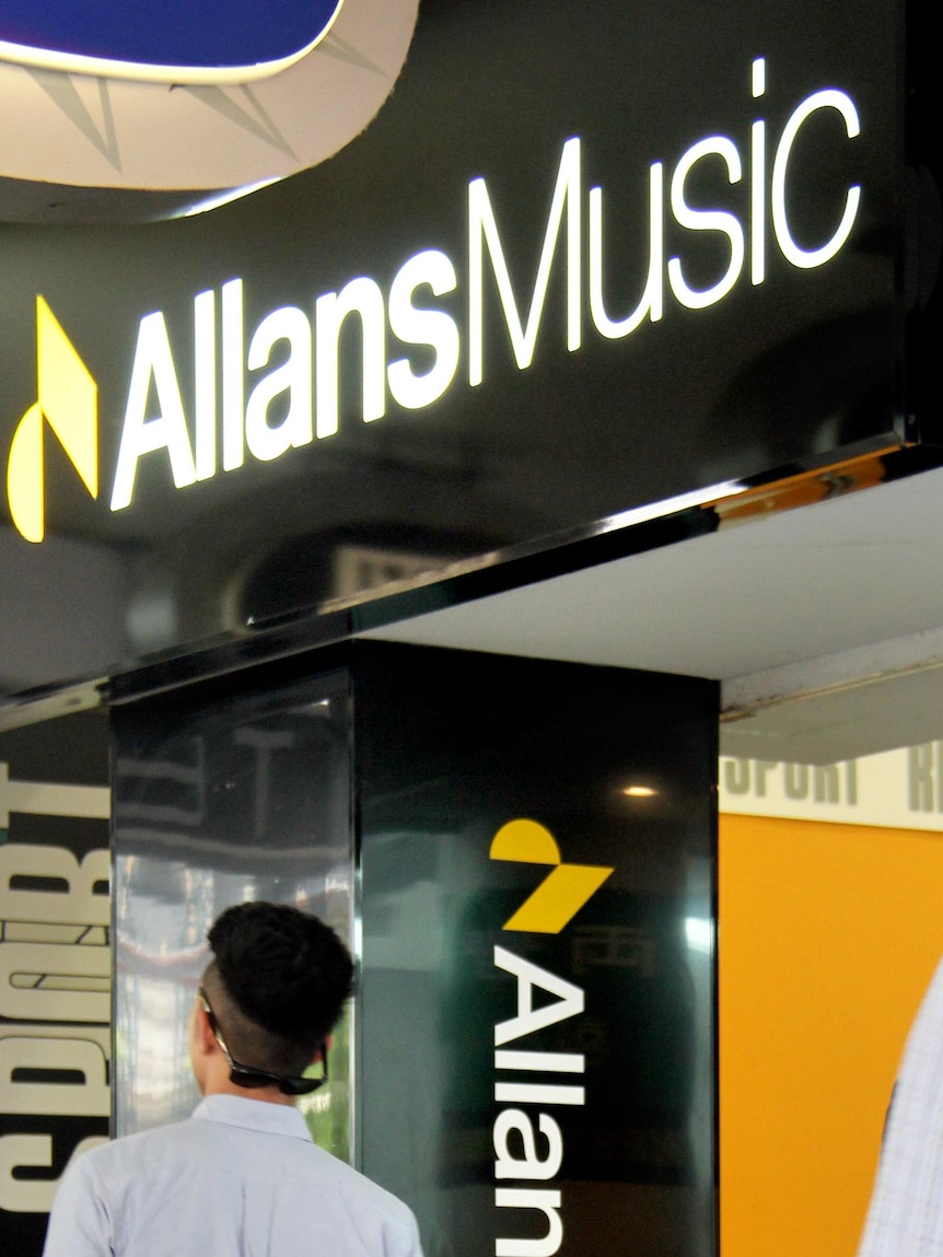 People walk past the Allans Music store entrance in the Queen Street Mall.