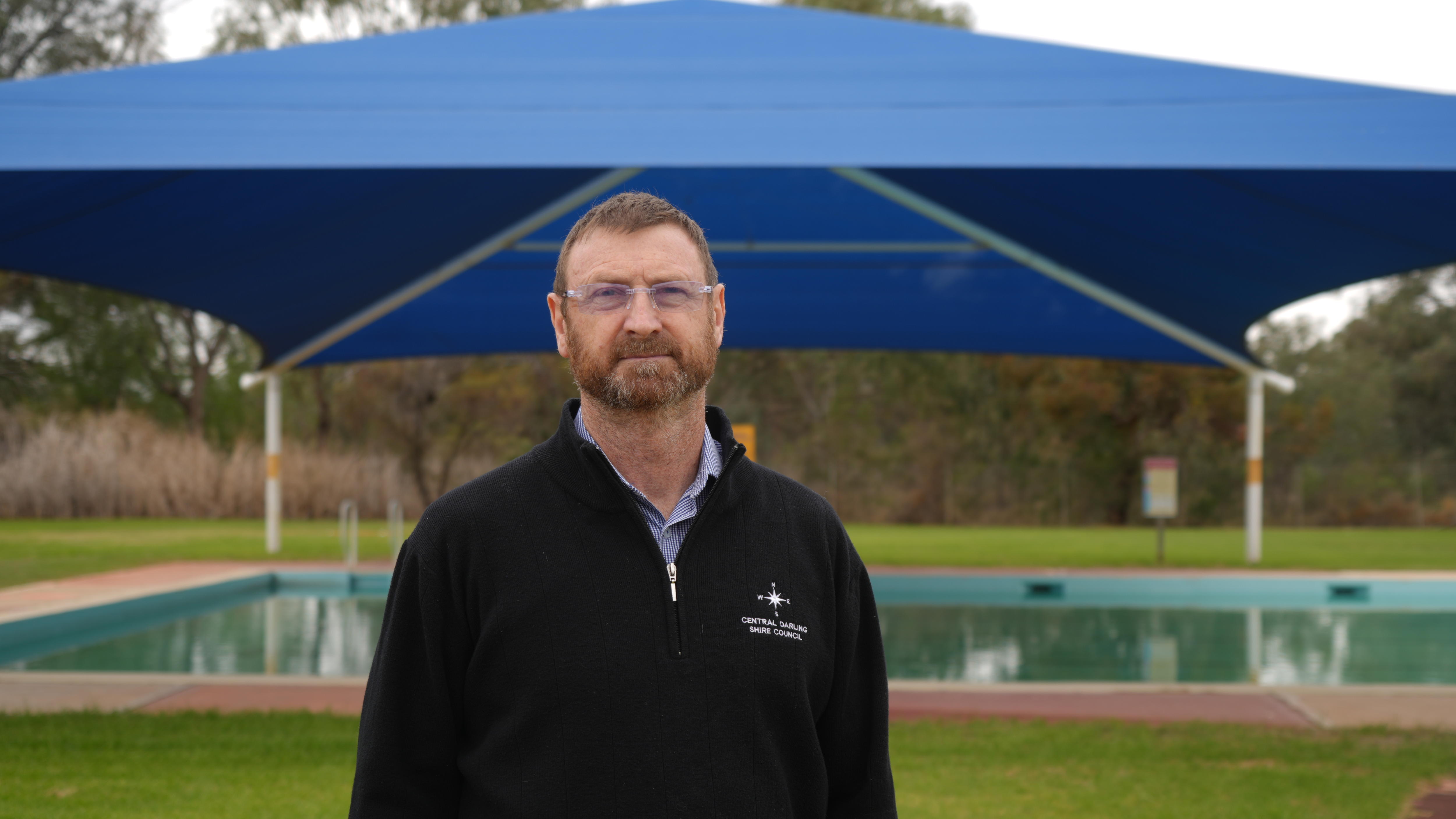 John Sevil stands in front of Wilcannia pool.