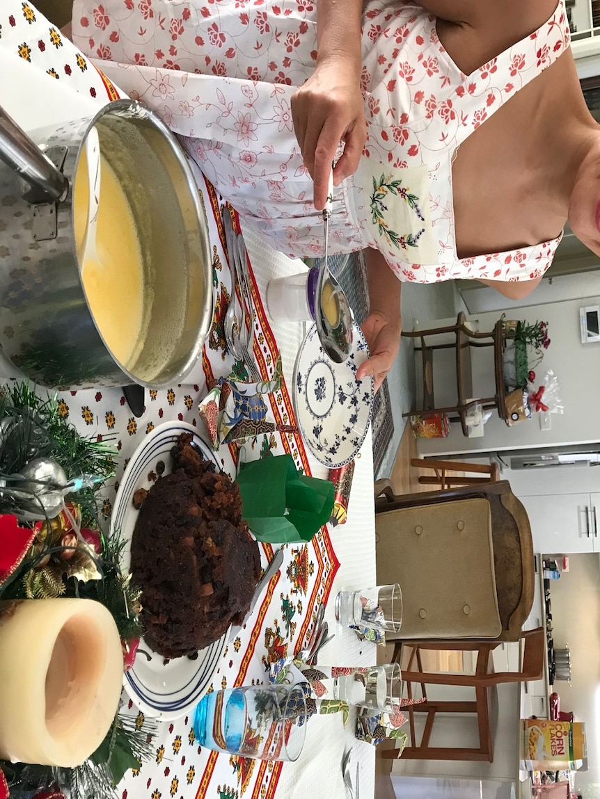 Yumi Stynes with Christmas pudding for story on women being expected to do too much for Christmas Day