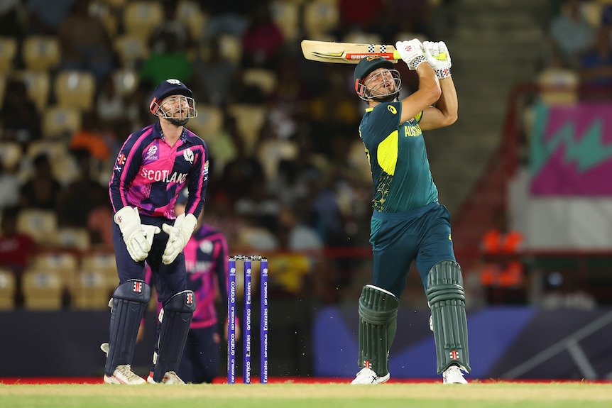 Marcus Stoinis completes a shot as Matthew Cross watches on from behind the stumps