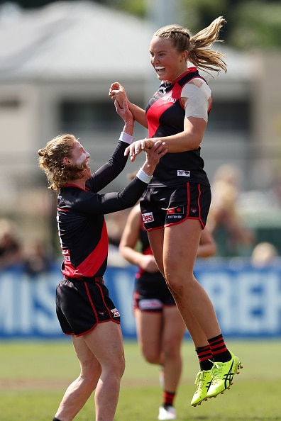 Emily Gough celebrating with teammates after a goal.