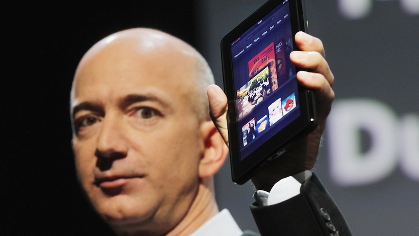 Amazon founder Jeff Bezos holds the new Amazon tablet called the Kindle Fire on September 28, 2011 in New York City.
