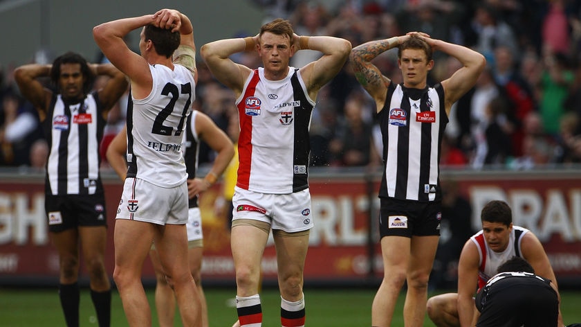 Stalemate... Saints Jason Blake and Brendon Goddard and Dayne Beams of the Pies show their dejection