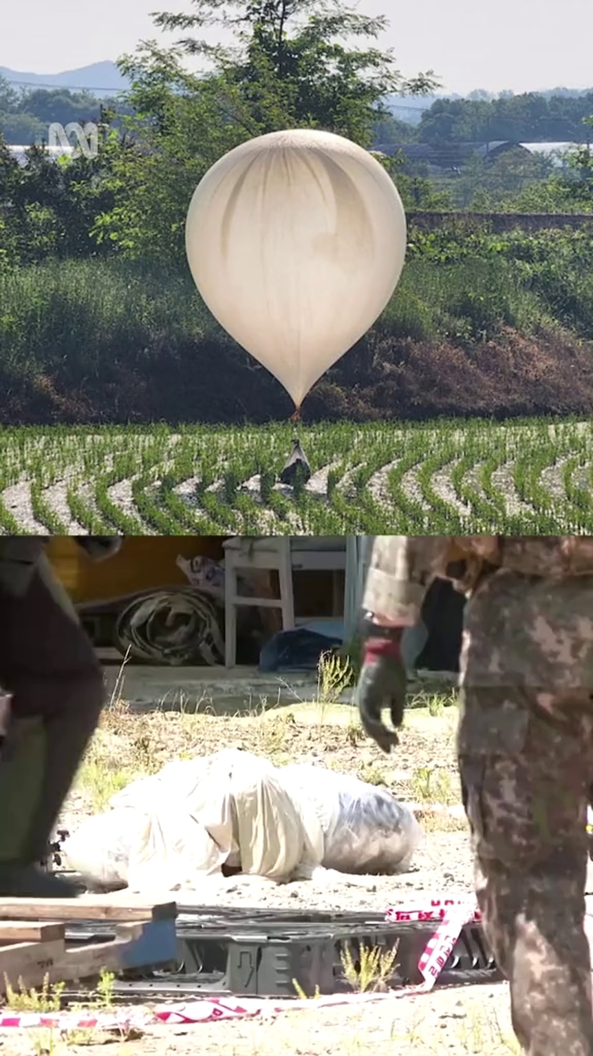 Composite shows a large white balloon in a rice paddy and figures in fatigues walking towards something wrapped in light fabric