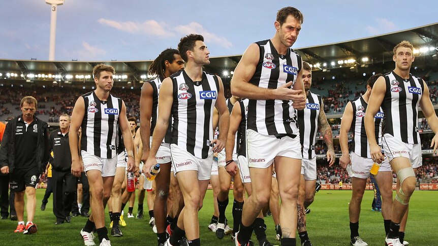 Travis Cloke and the Magpies walk off the MCG
