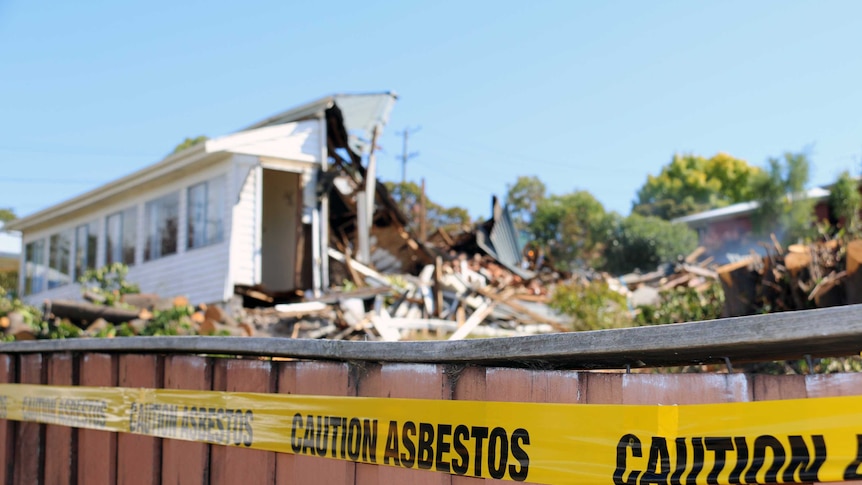 'Caution asbestos' tape around fence of demolished house in Mt Stuart, Hobart