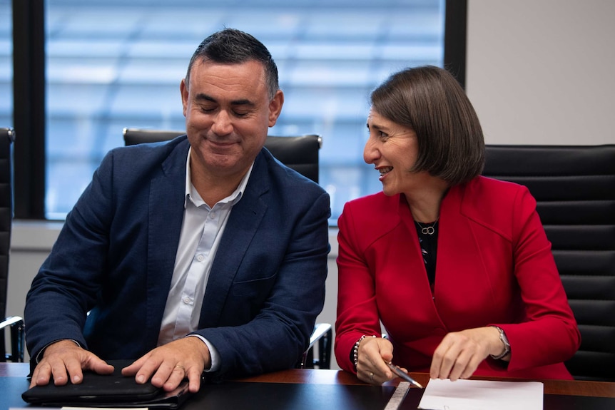 A man and a woman sitting at a table, laughing