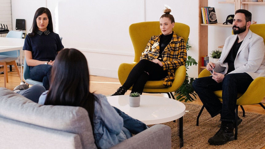 A couple and a woman sit in chairs facing two people on the couch, for a story about collaborative law and how it helps.